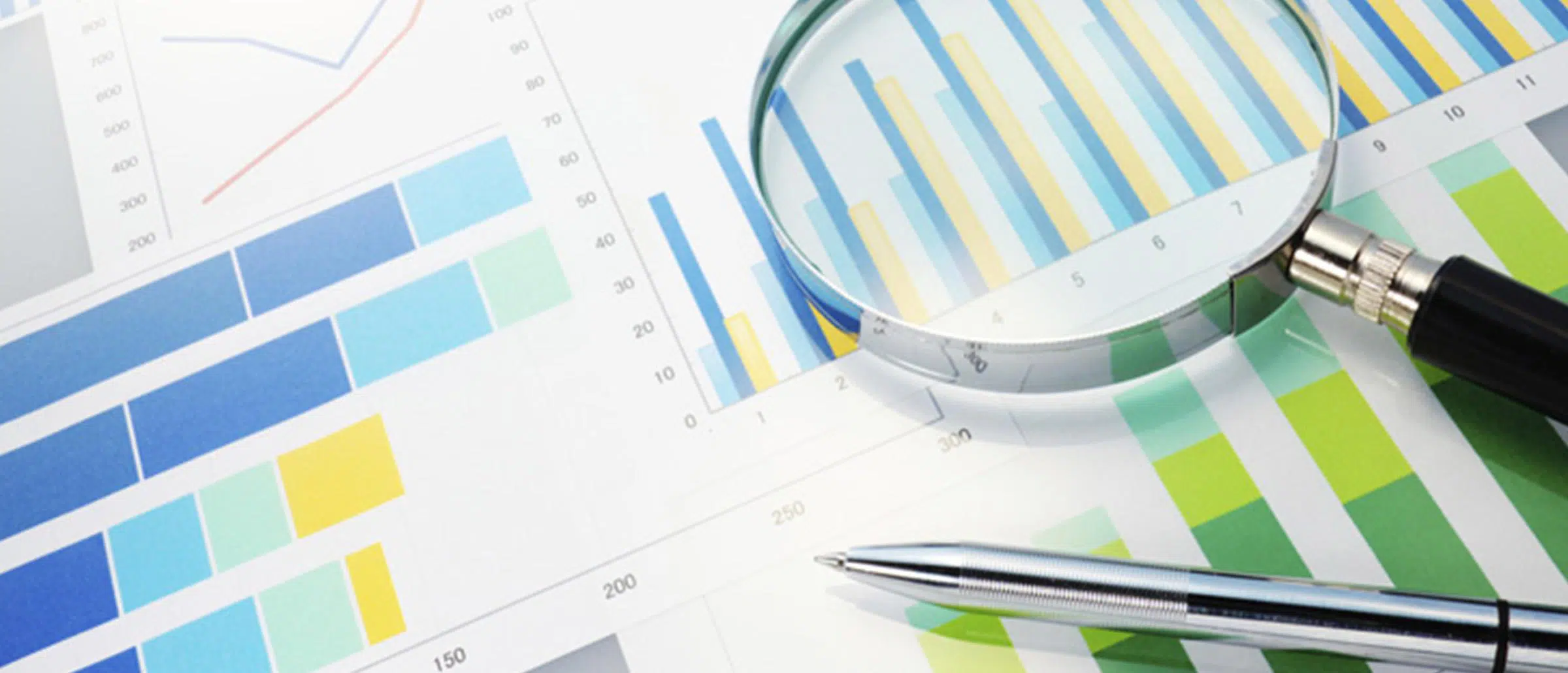 Magnifying glass focusing in on blue and yellow data bar charts